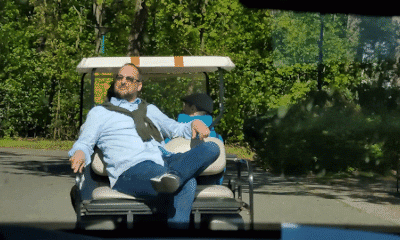A man on a golf cart.